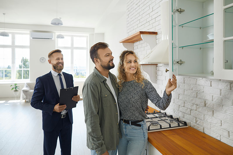 Couple viewing home with mortgage professional