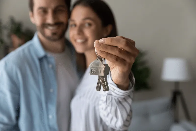 Couple Holding House Keys